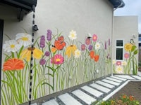 a colorful mural painted on the side of a house